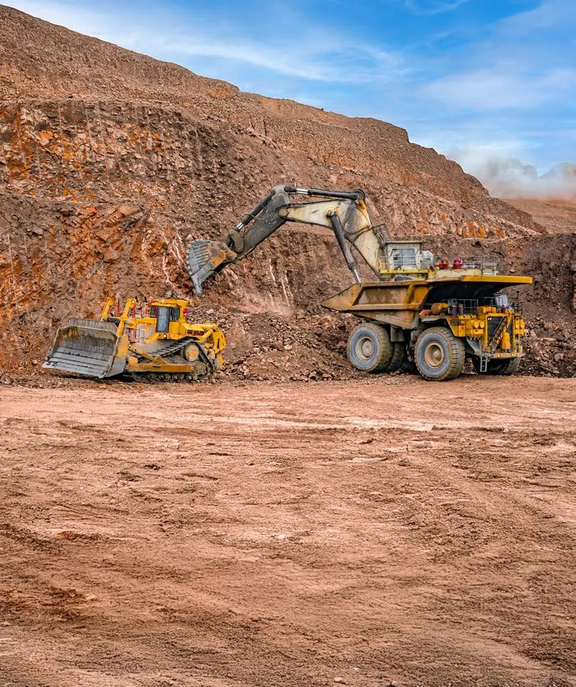 Excavator loading a haul truck in an open-pit mine